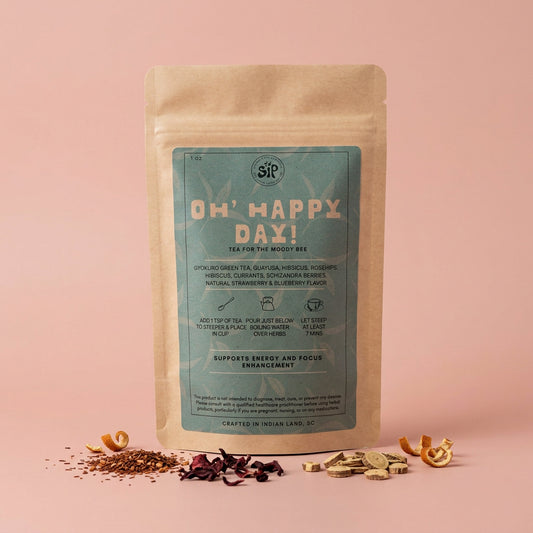 Oh' Happy Day! tea pouch on blush backdrop with scattered dried herbs
